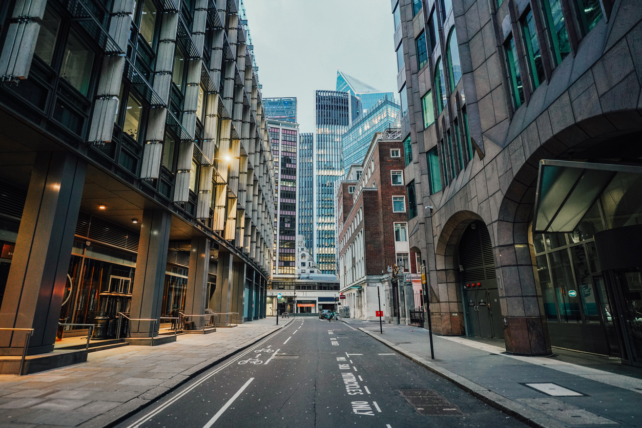 Quiet street surrounded by towering buildings in London