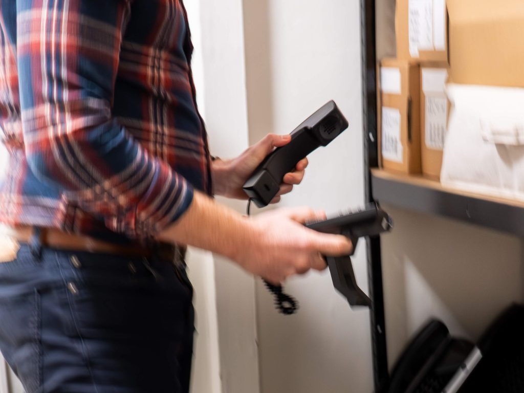 Ollie getting new phone order ready for client installation