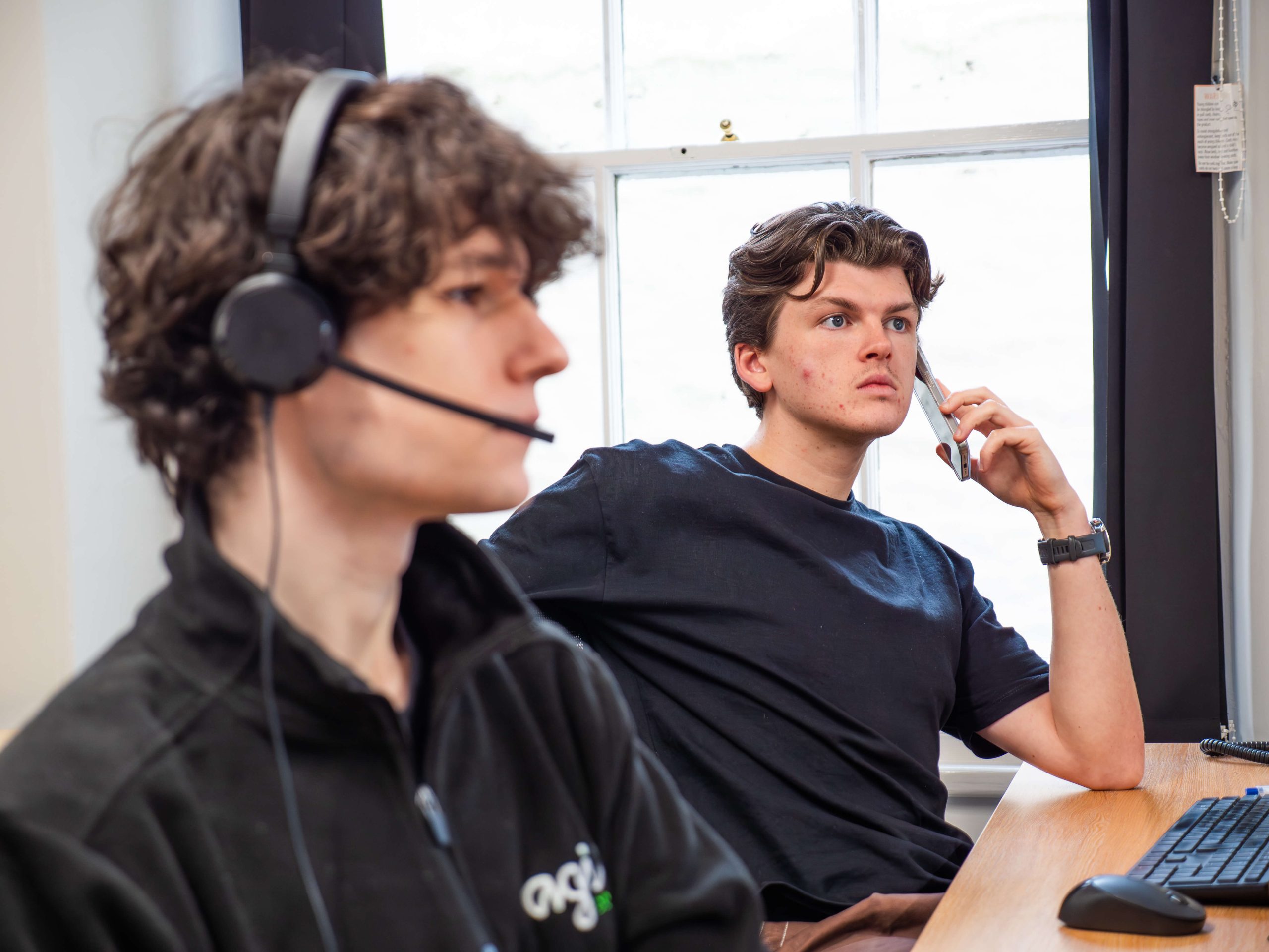 Bryn and Finlay on the phone to their clients